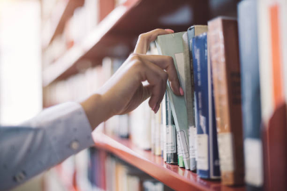 Hands reaching for a book