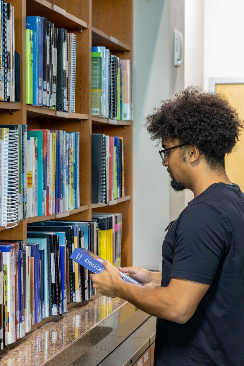 CSN Circulation Staff Checking in a Reserved Textbook